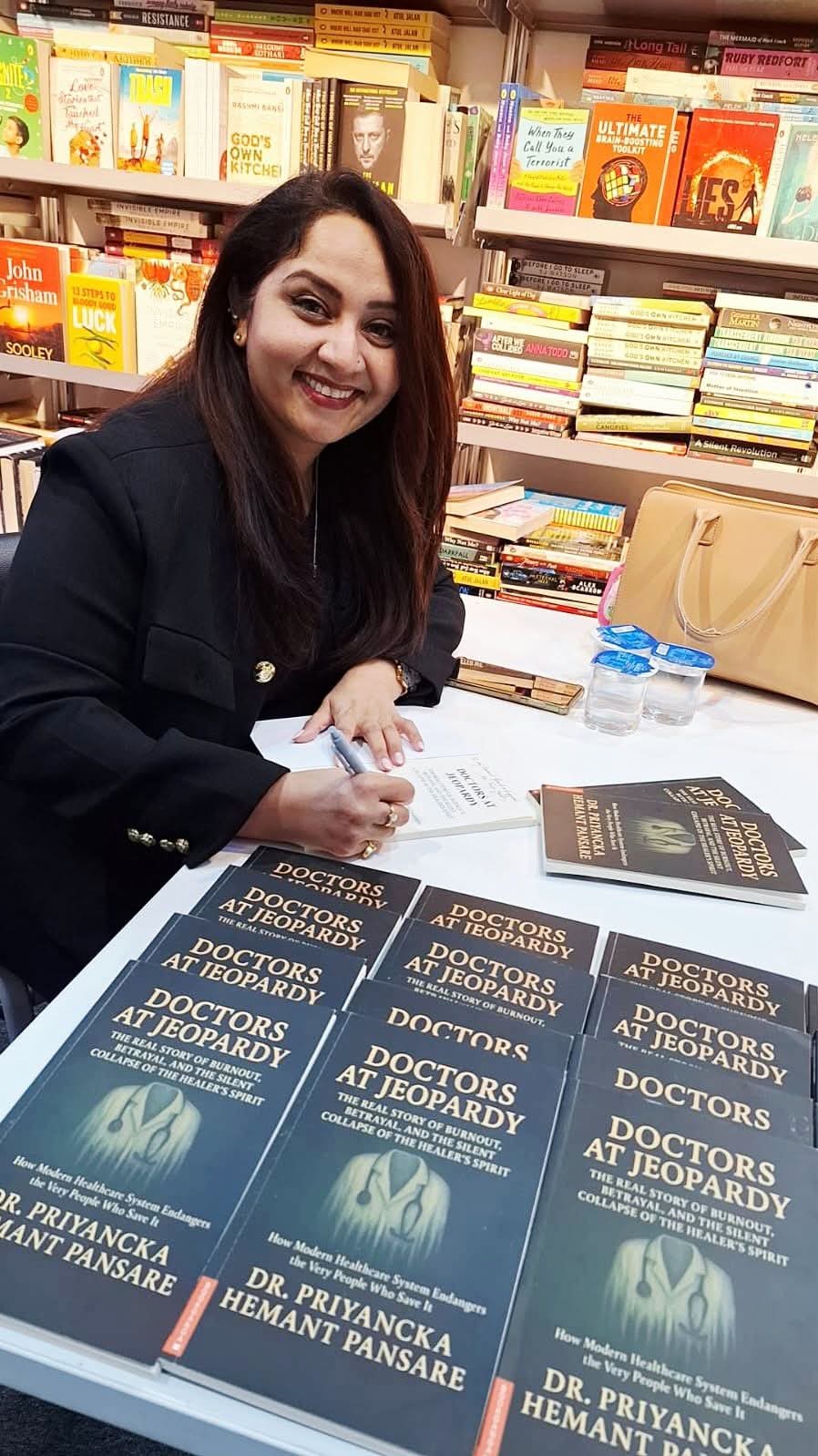 Dr. Priyancka Hemant Pansare signing copies of Doctors at Jeopardy at a book fair