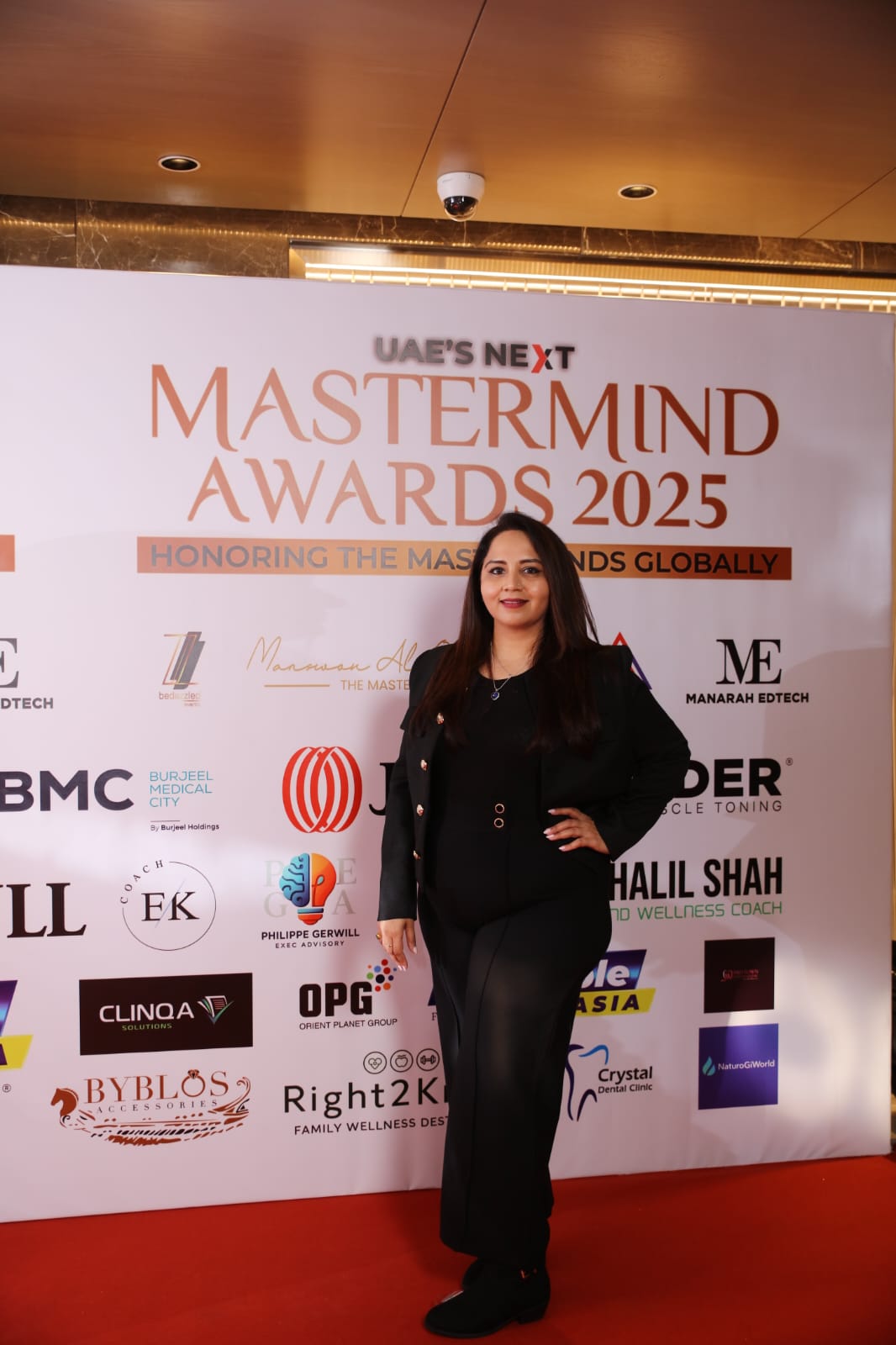 Dr. Priyancka Pansare at the UAE's Next Mastermind Awards 2025 backdrop in Dubai