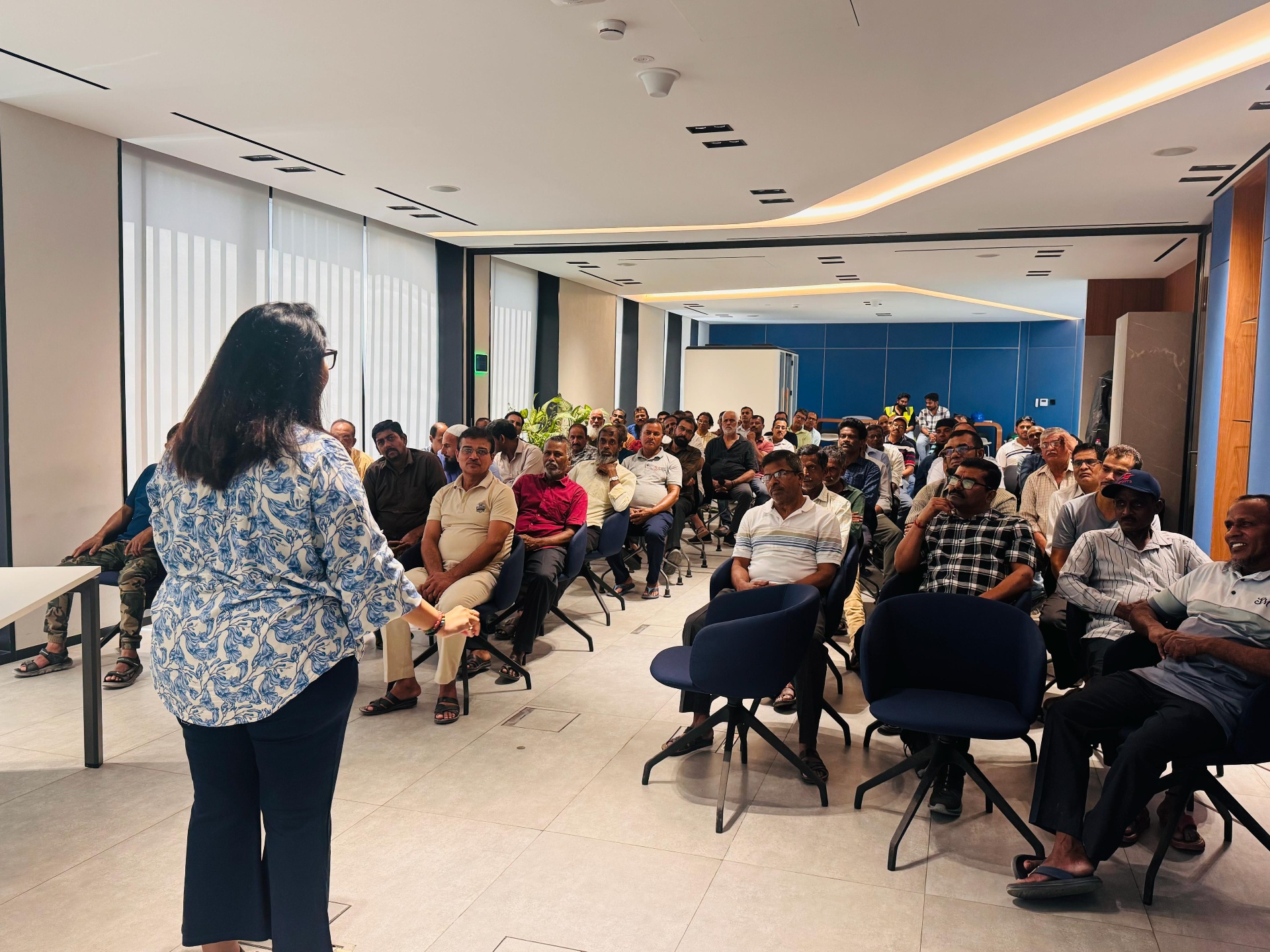 Dr. Priyancka Pansare speaking to a full room of frontline workers at a UAE health awareness session