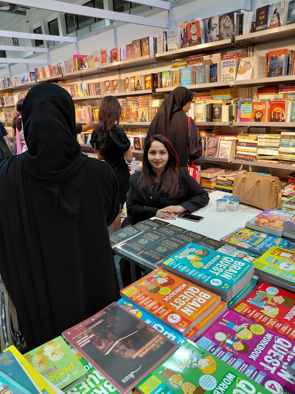 Dr. Priyancka Hemant Pansare at her Doctors at Jeopardy book stall during a book fair, copies on display